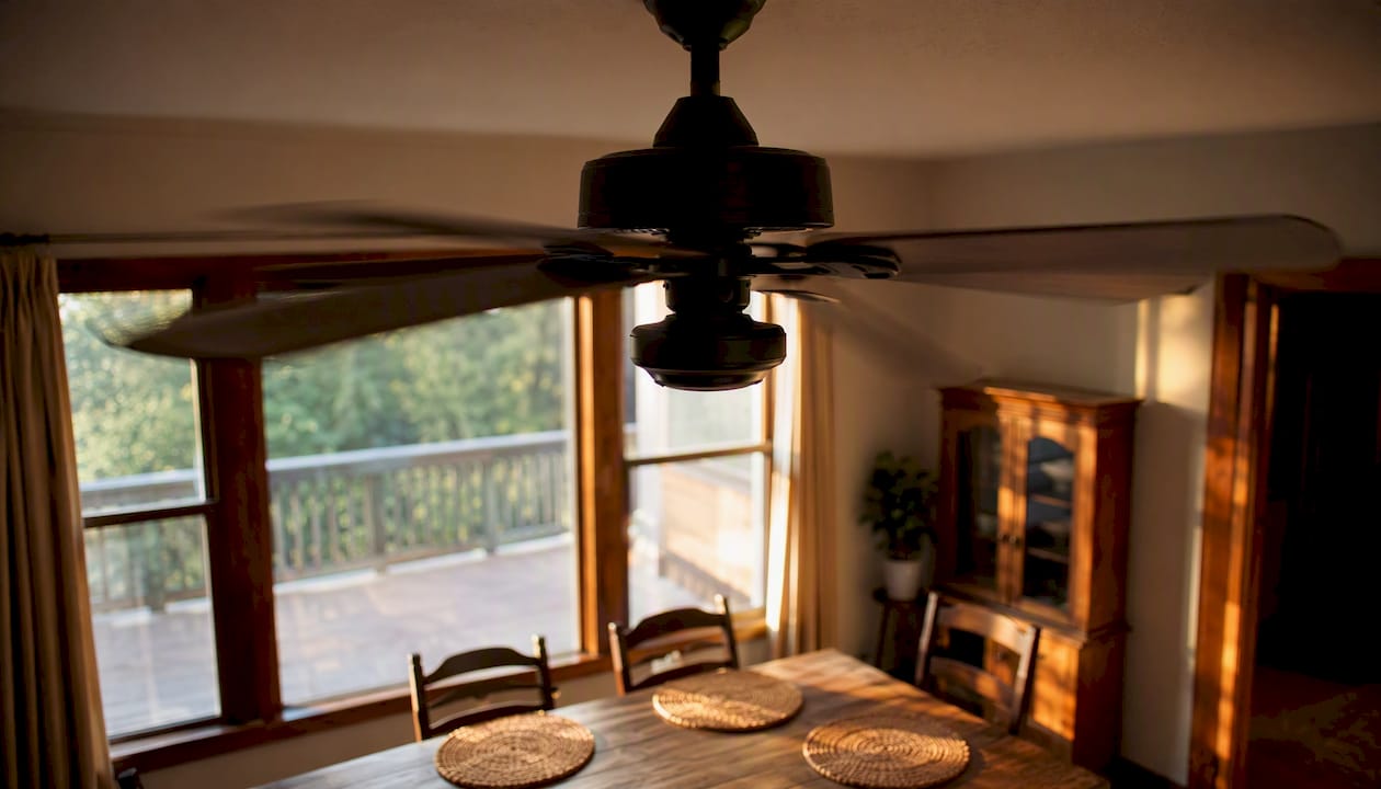 Ceiling fan spinning indoors for cooling