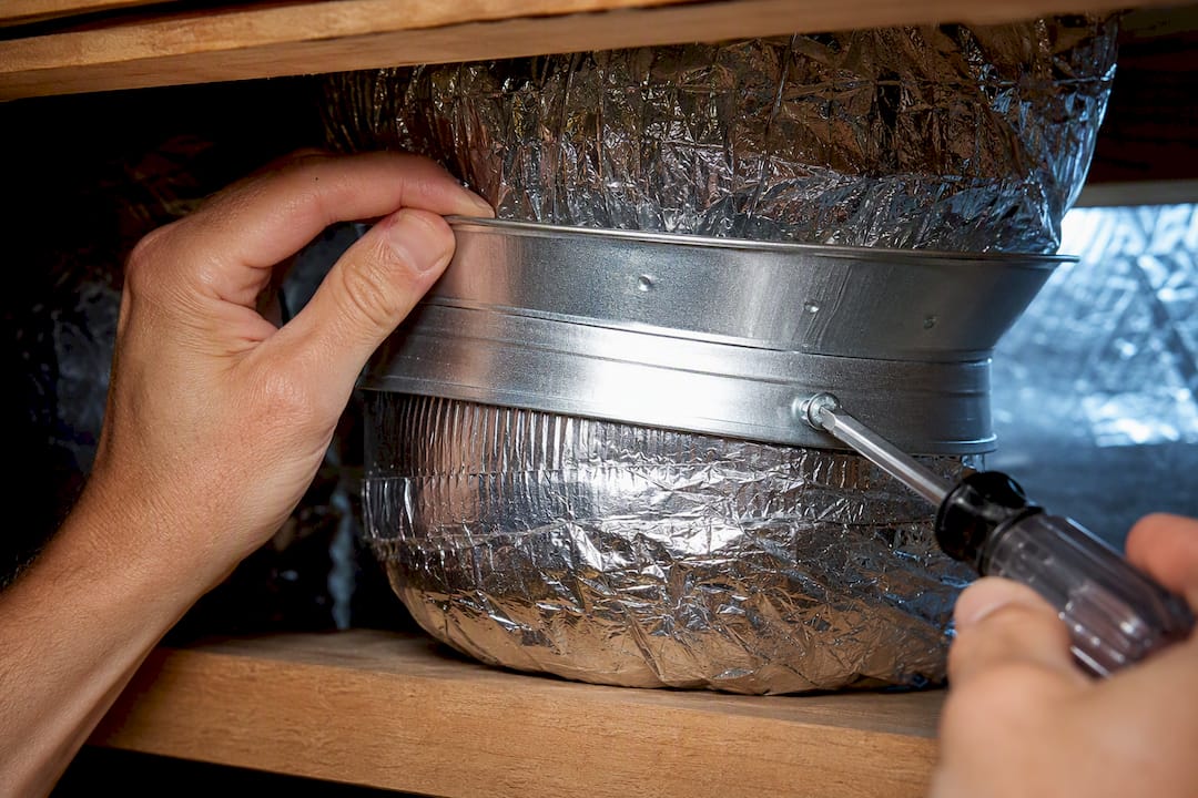 Hands reattaching a loose duct boot